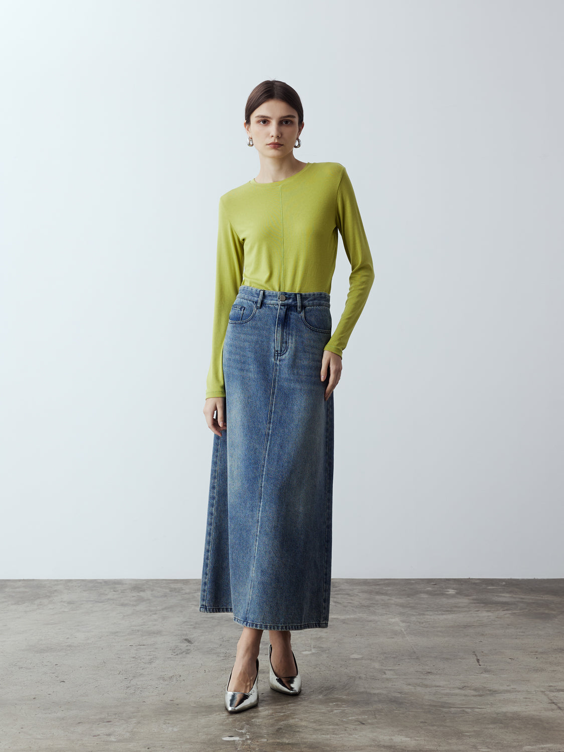 lime : Model is wearing the Fitted Long Sleeve T-Shirt in Lime, which comes with a rounded crew neckline and a centre front stitch line. Arm-hugging but gives a relaxed bodice. Worn with Denim Maxi Skirt and metallic silver heels.