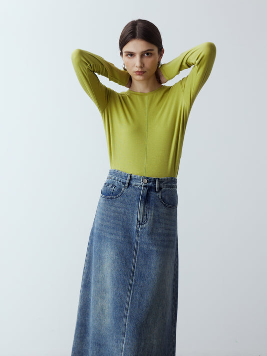Model is wearing the Fitted Long Sleeve T-Shirt in Lime, which comes with a rounded crew neckline and a centre front stitch line. Arm-hugging but gives a relaxed bodice. Worn with Denim Maxi Skirt and metallic silver heels.