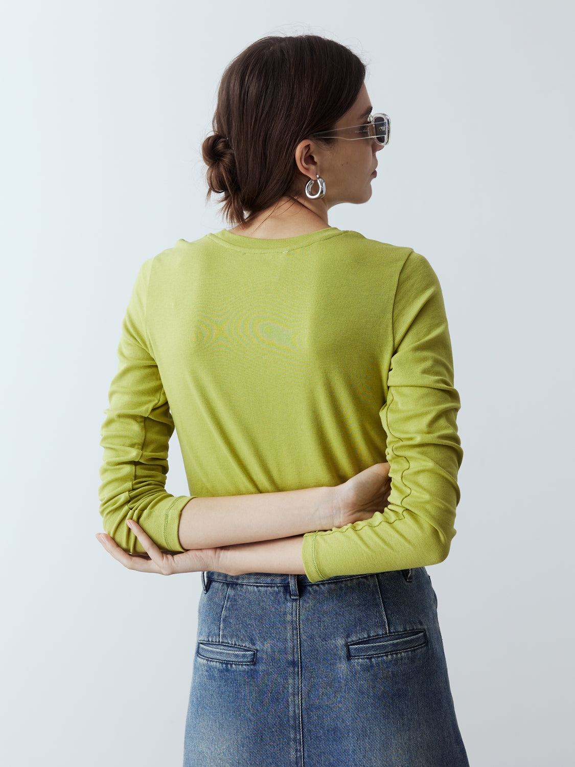 lime : Model is wearing the Fitted Long Sleeve T-Shirt in Lime, which comes with a rounded crew neckline and a centre front stitch line. Arm-hugging but gives a relaxed bodice. Worn with Denim Maxi Skirt and metallic silver heels.
